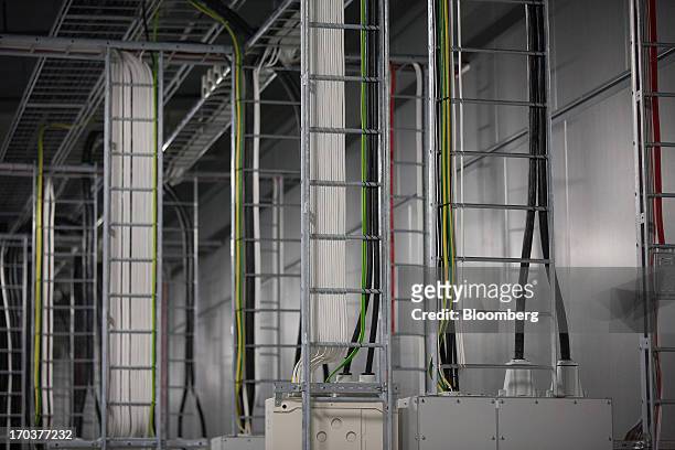 Electrical wires hang inside the fan room used to cool the server halls inside Facebook Inc.'s new data storage center near the Arctic Circle in...