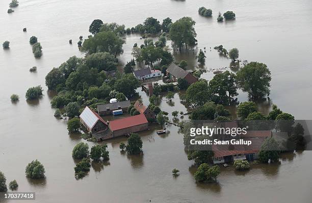 In this aerial view farms stand partially submerged in floodwaters from the Elbe river on June 12, 2013 near Wittenberge, Germany. The swollen Elbe...