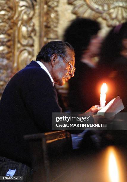 An elderly man prays in front of an altar at San Francisco's Catholic Church in Quito April 12, 2001. Un anciano reza delante de un altar en la...