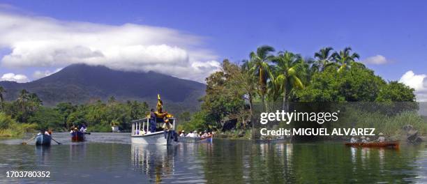 Catholic believers sail along the Via Crucis boat, adorned with flowers, to cross the lake Cocibolca and reach the small Granada islands 10 April...