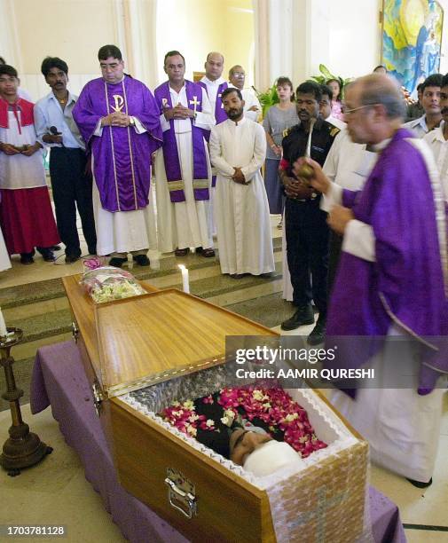 Christian clergy pray during the funeral service of one of seven victims of last week's massacre, held at Victorian-era St Patrick's Cathedral in...