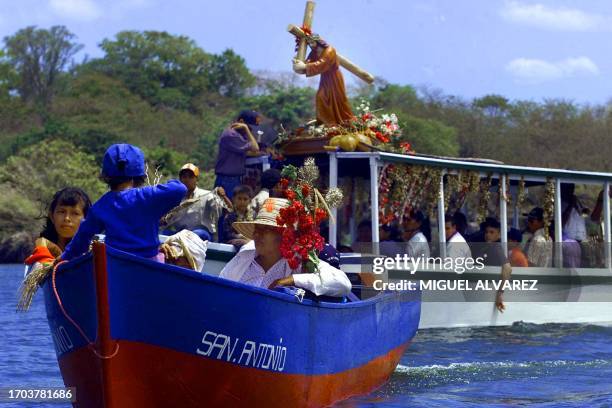 Catholic believers sail along the Via Crucis boat, adorned with flowers, to cross the lake Cocibolca and reach the small Granada islands 10 April...