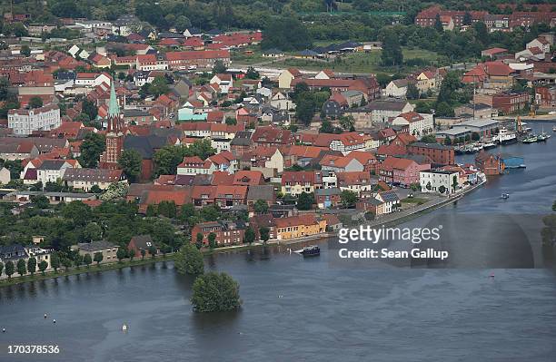In this aerial view the swollen Elbe river flows past the historic city center on June 12, 2013 at Wittenberge, Germany. The swollen Elbe is...