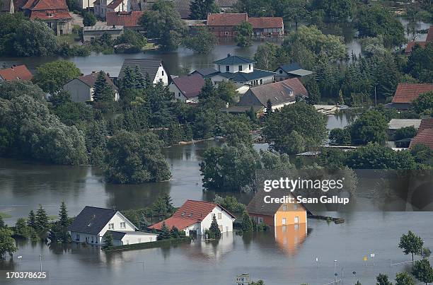 In this aerial view houses stand partially submerged in floodwaters from the Elbe river on June 12, 2013 in Fischbeck, Germany. The swollen Elbe is...