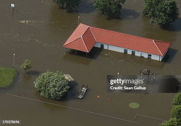 In this aerial view a building, playground and basketball hoop stand partially submerged in floodwaters from the Elbe river on June 12, 2013 near...