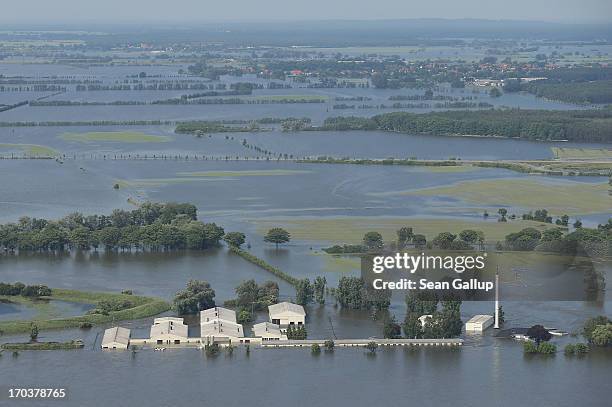 In this aerial view a farm stands partially submerged in floodwaters from the Elbe river on June 12, 2013 in Fischbeck, Germany. The swollen Elbe is...