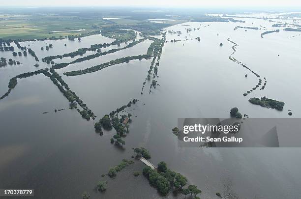 In this aerial view floodwaters from the Elbe river spread across communities on June 12, 2013 near Fischbeck, Germany. The swollen Elbe is...