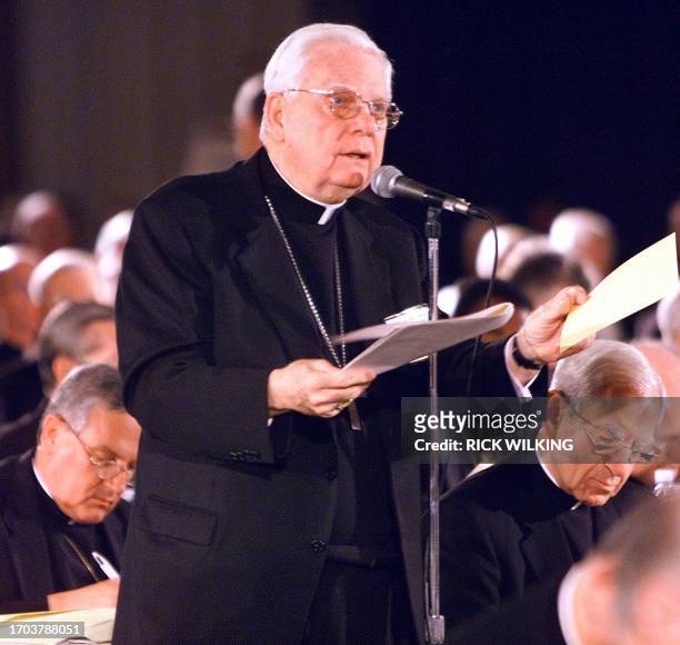 Bishop Bernard Law of Boston holds a draft of the policy as he asks for clarification during the United States Conference of Catholic Bishops 14 June...