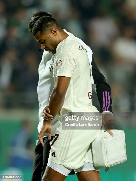 Serge Gnabry of Bayern Munich leaves injured the pitch during the DFB cup first round match between Preußen Münster and FC Bayern München at...