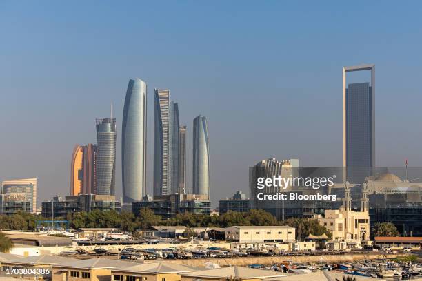 The Etihad Towers, left, and the headquarters of the Abu Dhabi National Oil Co. , right, in Abu Dhabi, United Arab Emirates, on Tuesday, Oct. 3,...