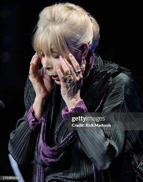 Joni Mitchells wipes the tears from her face after coming on stage at the conclusion of the Canadian Songwriters Hall of Fame induction ceremony. The...