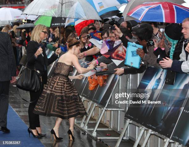 Actress Amy Adams signs autographs for fans as she attends the UK Premiere of 'Man of Steel' at Odeon Leicester Square on June 12, 2013 in London,...