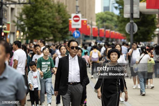 Pedestrians and shoppers on Nanjing Road shopping street in Shanghai, China, on Tuesday, Oct. 3, 2023. China's Golden Week got off to a promising...