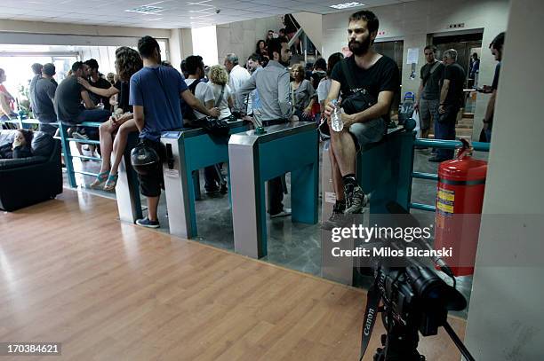 Workers occupy an entrance to the headquarters of the Greek public broadcaster ERT on June 12, 2013 in Athens, Greece. Journalists have refused to...