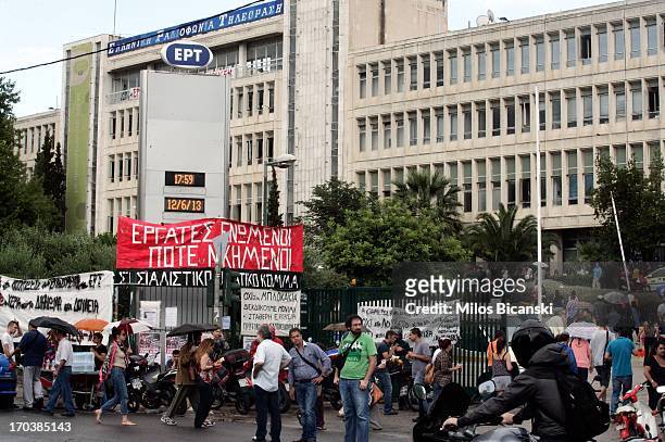 People arrive to support staff occupying the headquarters of the Greek public broadcaster ERT following the announcement of corporations closure on...