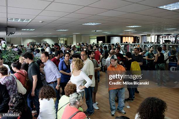 People occupy the main hall of the headquarters of the Greek public broadcaster ERT on June 12, 2013 in Athens, Greece. Journalists have refused to...