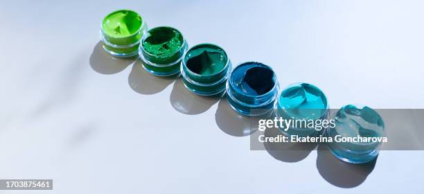 banner with tubes of green and blue acrylic paint in different shades - paint tube stock pictures, royalty-free photos & images