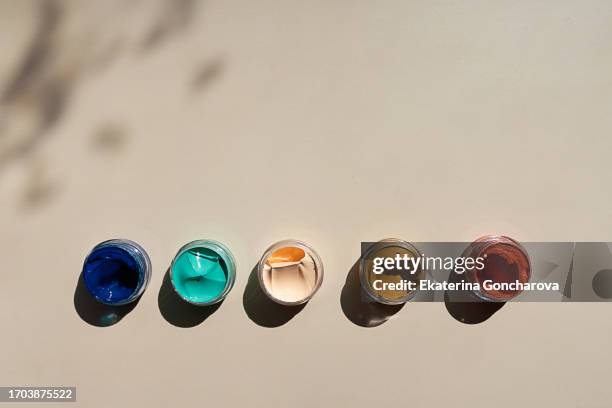 multicolored paints on a beige background with copy space - group from above stock pictures, royalty-free photos & images