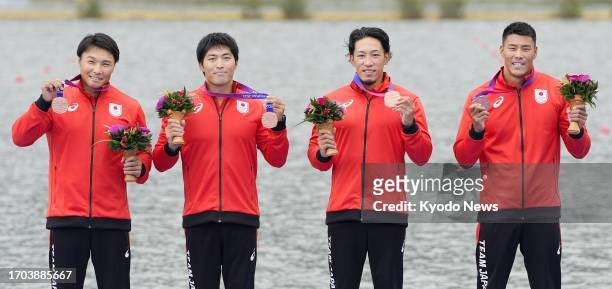 Members of Japanese team celebrate after winning bronze in the men's kayak four 500-meter event at the Asian Games in Hangzhou, China, on Oct. 3,...