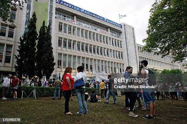 People arrive to support staff occupying the headquarters of the Greek public broadcaster ERT following the announcement of corporations closure on...