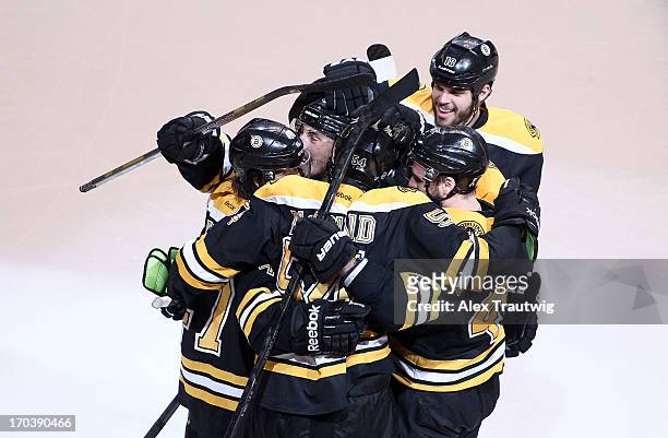 Adam McQuaid of the Boston Bruins celebrates with teammates after scoring a goal in the third period against the Pittsburgh Penguins in Game Four of...