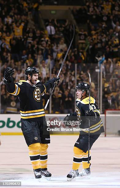 Adam McQuaid and Torey Krug of the Boston Bruins celebrate after McQuaid scores in the third period against the Pittsburgh Penguins in Game Four of...