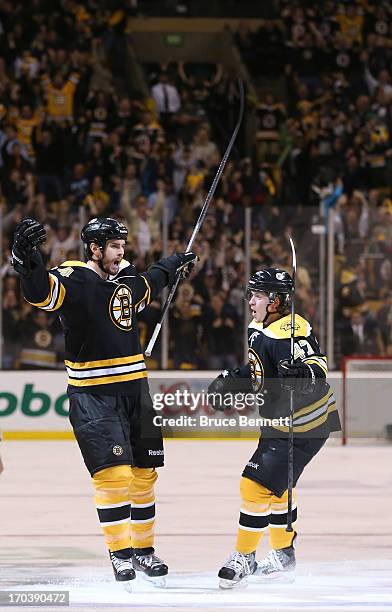 Adam McQuaid and Torey Krug of the Boston Bruins celebrate after McQuaid scores in the third period against the Pittsburgh Penguins in Game Four of...