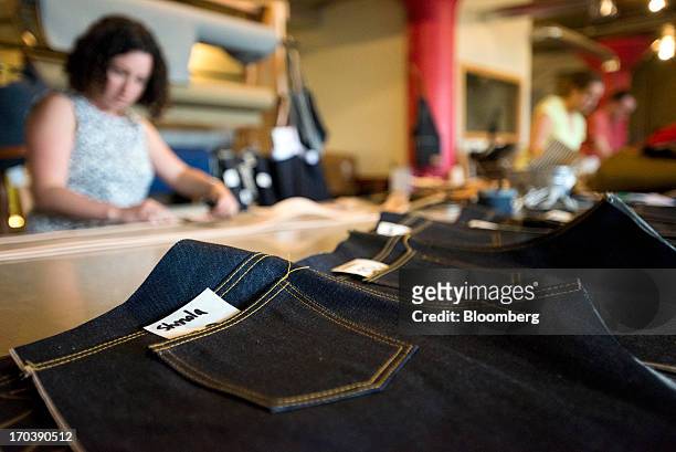 Employees create pairs of denim jeans at Detroit Denim, in Detroit, Michigan, U.S., on Wednesday, June 12, 2013. The Commerce Department is scheduled...