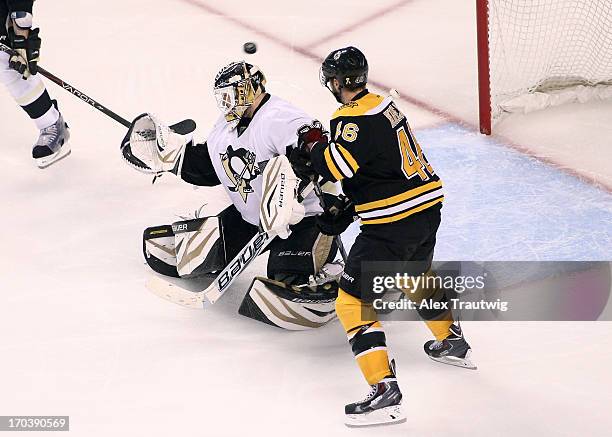 Tomas Vokoun of the Pittsburgh Penguins fails to make a save on a shot by Adam McQuaid of the Boston Bruins in Game Four of the Eastern Conference...