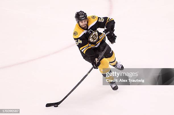 Adam McQuaid of the Boston Bruins handles the puck against the Pittsburgh Penguins in Game Four of the Eastern Conference Final during the 2013...