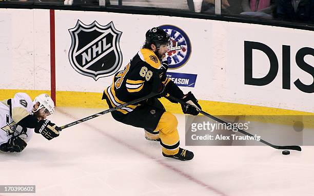 Jaromir Jagr of the Boston Bruins handles the puck against Pascal Dupuis of the Pittsburgh Penguins in Game Four of the Eastern Conference Final...