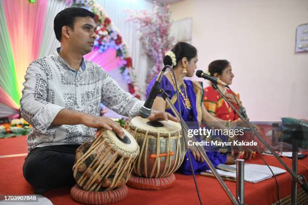 a skilled tabla musician with two women classical singers singing a classical song, weaving an enchanting musical tale - tabla stock pictures, royalty-free photos & images