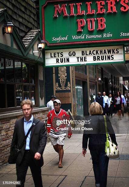 Pedestrians pass a sign showing support for the Chicago Blackhawks in the Loop on June 12, 2013 in Chicago, Illinois. The Chicago Blackhawks will...