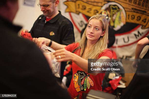 Rachel Dettloff rings up merchadise for a customer at the Blackhawks Store on Michigan Avenue in the Loop on June 12, 2013 in Chicago, Illinois. The...
