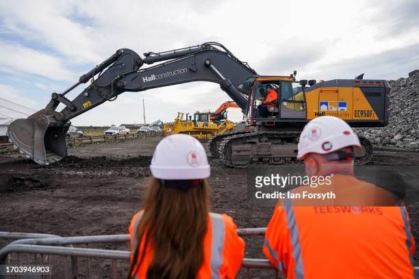 Employees watch as Tees Valley Mayor Ben Houchen operates plant machinery during a photo call at a ceremony to mark the ground-breaking of the Net...