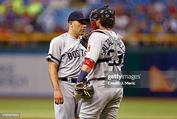 Catcher Jarrod Saltalamacchia of the Boston Red Sox talks with pitcher Alfredo Aceves during the game against the Tampa Bay Rays at Tropicana Field...