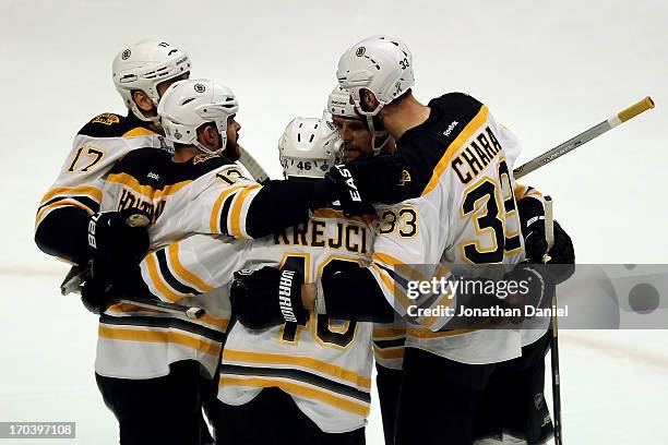 Milan Lucic, Nathan Horton, David Krejci, Dennis Seidenberg and Zdeno Chara of the Boston Bruins celebrate after Lucic scored a goal in the first...