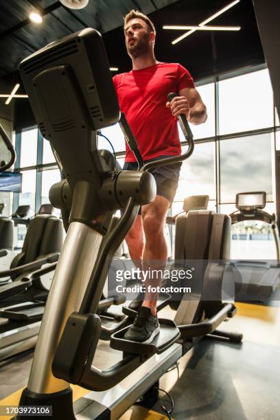 cardio workout routine on an elliptical machine - cardio machine stock pictures, royalty-free photos & images
