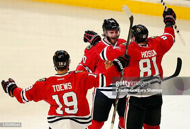 Jonathan Toews, Brandon Saad and Marian Hossa of the Chicago Blackhawks celebrate after Saad scored a second period goal in the second period against...