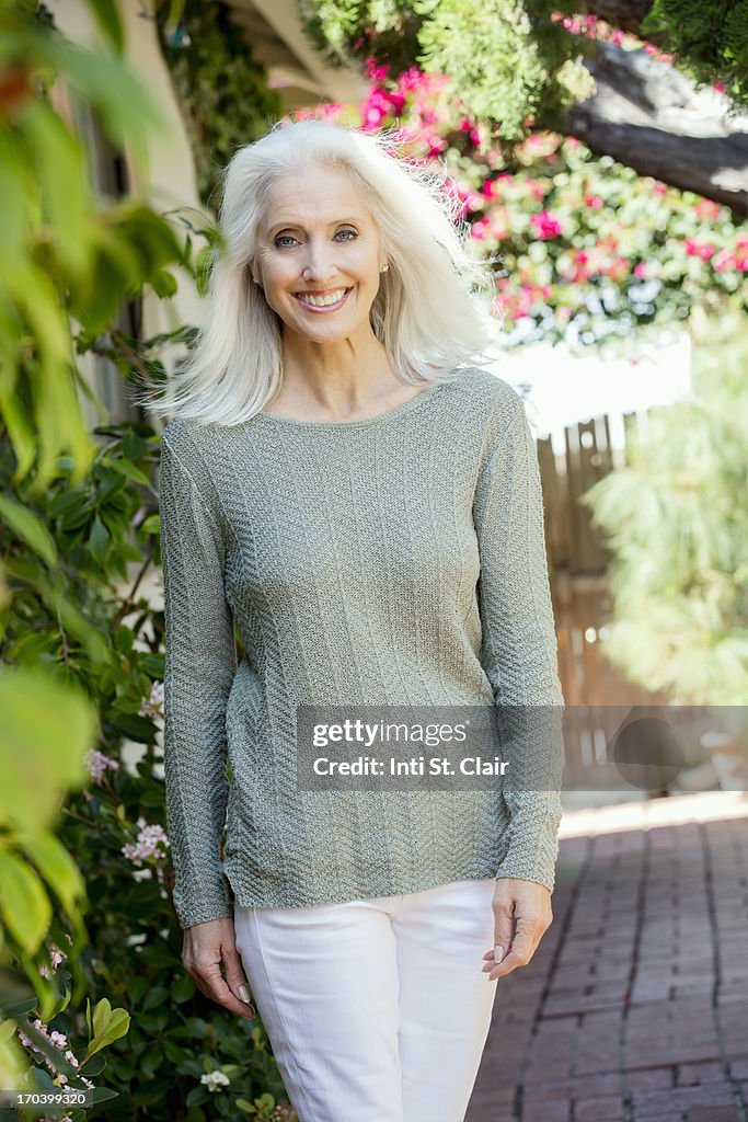 Smiling mature woman outside on home patio