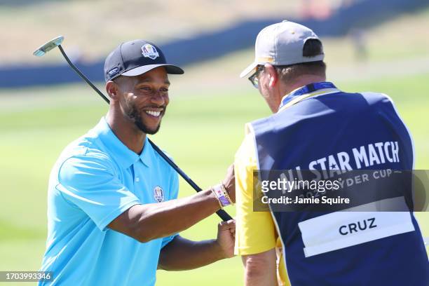 Former American Football Player, Victor Cruz interacts with his caddie on the first green during the All-Star Match at the 2023 Ryder Cup at Marco...