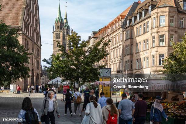 Shoppers walk along a pedestrianized shopping street in Nuremberg, Germany, on Monday, Oct. 2, 2023. German inflation plunged to its lowest level in...