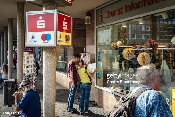 Tourists look at a map outside a tourist information shop in Nuremberg, Germany, on Monday, Oct. 2, 2023. German inflation plunged to its lowest...