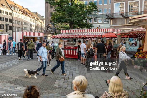 Shoppers pass a crepe food stall in Nuremberg, Germany, on Monday, Oct. 2, 2023. German inflation plunged to its lowest level in two years after the...