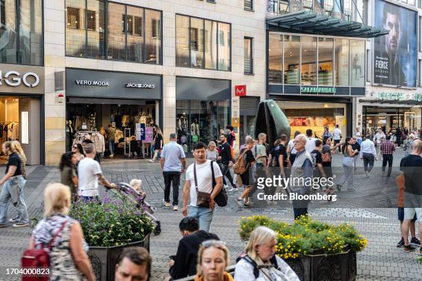 Shoppers walk along a pedestrianized shopping street in Nuremberg, Germany, on Monday, Oct. 2, 2023. German inflation plunged to its lowest level in...
