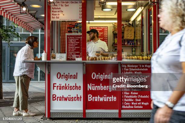 Customer at a bratwurst food kiosk in Nuremberg, Germany, on Monday, Oct. 2, 2023. German inflation plunged to its lowest level in two years after...