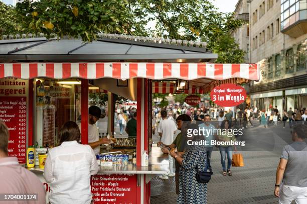 Customer at a bratwurst food kiosk in Nuremberg, Germany, on Monday, Oct. 2, 2023. German inflation plunged to its lowest level in two years after...