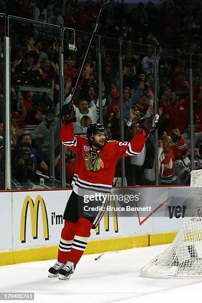 Michael Frolik of the Chicago Blackhawks celebrates after teammate Johnny Oduya scored a goal in the third period against the Boston Bruins in Game...