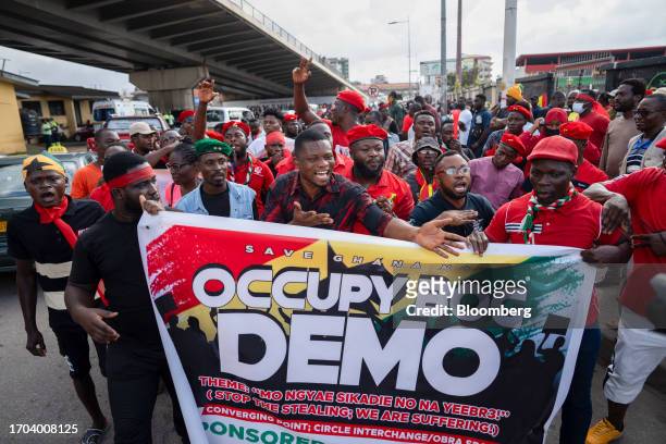Demonstrators hold an event banner during an 'Occupy Bank of Ghana' protest in Accra, Ghana, on Tuesday, Oct. 3, 2023. The demonstration is the...