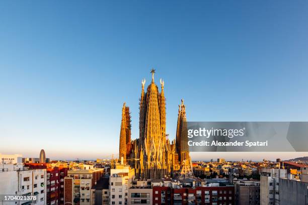 barcelona cityscape with sagrada familia at sunset, spain - sagrada familia barcelona stock pictures, royalty-free photos & images
